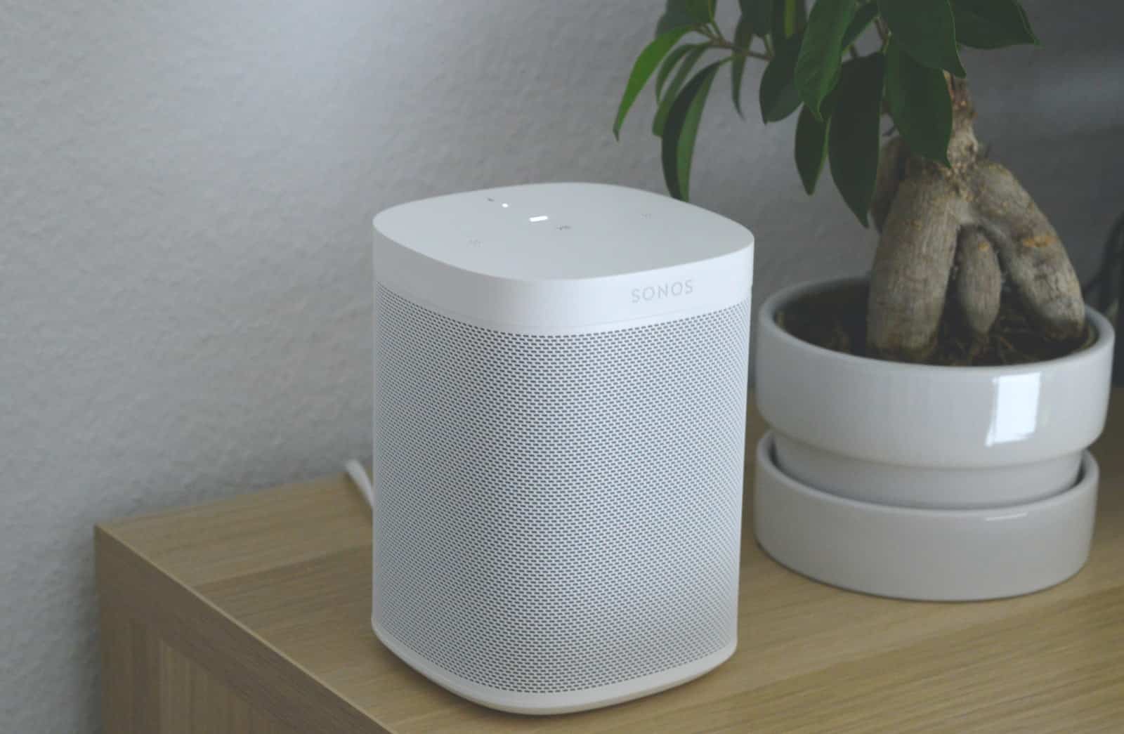 white portable speaker on brown wooden table