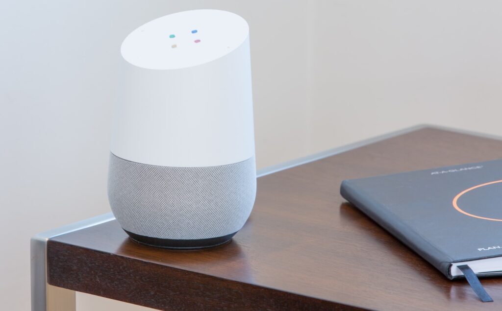 white and gray Google home on brown table - Smart Home Voice Assistant