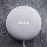 round white portable speaker on black textile